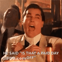 A Man In A Suit And Tie Is Saying `` He Said `` Is That A Paid Day Off '' While Holding A Candle . GIF