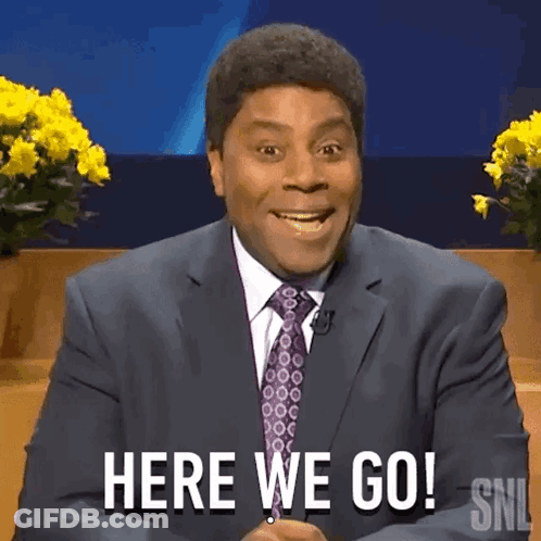 A Man In A Suit And Tie Is Saying Here We Go GIF