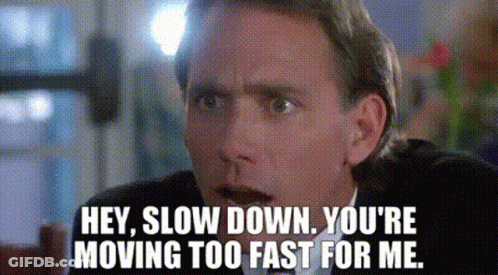 A Man In A Suit And Tie Is Saying `` Hey , Slow Down . You 'Re Moving Too Fast For Me . '' GIF