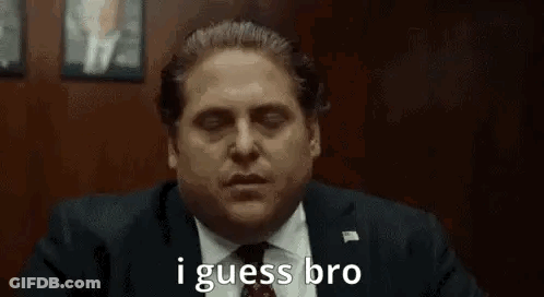 A Man In A Suit And Tie Is Saying `` I Guess Bro '' While Sitting In A Chair . GIF