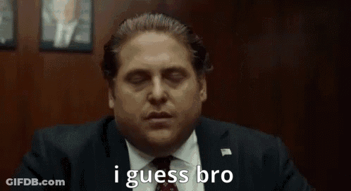 A Man In A Suit And Tie Is Saying `` I Guess Bro '' While Sitting In A Chair . GIF