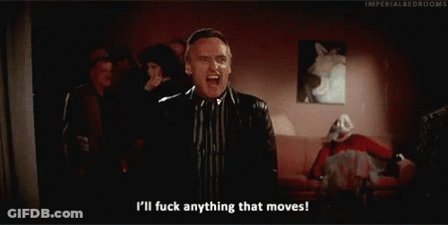 A Man In A Suit And Tie Is Saying I 'Ll Fuck Anything That Moves . GIF