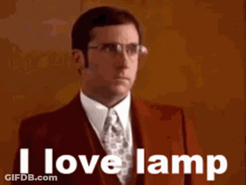 A Man In A Suit And Tie Is Saying I Love Lamp . GIF