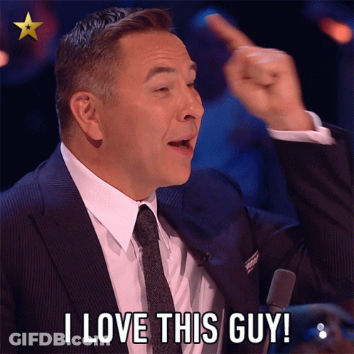 A Man In A Suit And Tie Is Saying " I Love This Guy " GIF