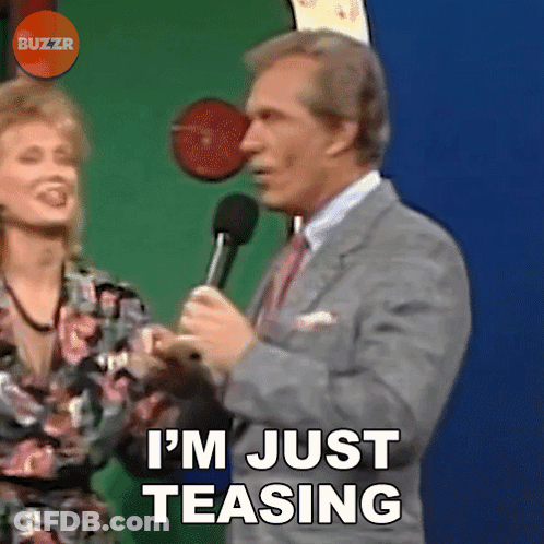 A Man In A Suit And Tie Is Saying I 'M Just Teasing GIF