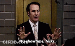 A Man In A Suit And Tie Is Saying It 'S Showtime Folks . GIF
