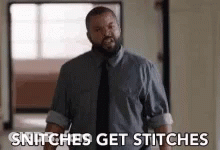 A Man In A Suit And Tie Is Saying Snitches Get Stitches . GIF