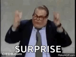 A Man In A Suit And Tie Is Saying Surprise . GIF