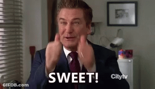 A Man In A Suit And Tie Is Saying Sweet With His Hands In The Air . GIF