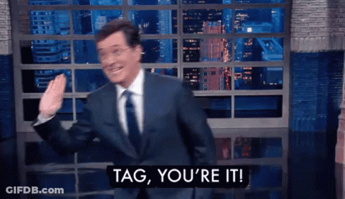 A Man In A Suit And Tie Is Saying Tag , You 'Re It GIF