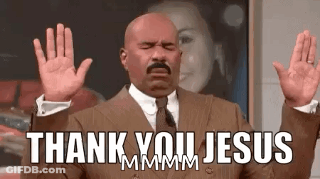 A Man In A Suit And Tie Is Saying Thank You Jesus With His Hands In The Air . GIF