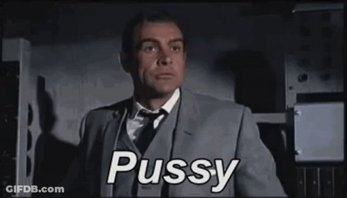 A Man In A Suit And Tie Is Saying The Word Pussy . GIF