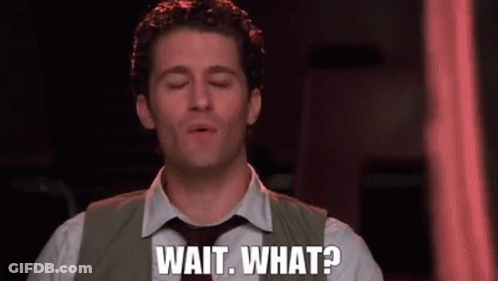 A Man In A Suit And Tie Is Saying Wait What . GIF