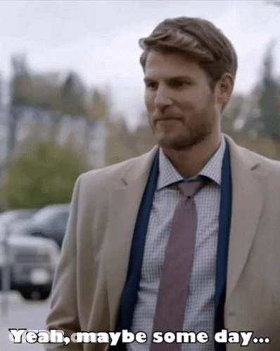 A Man In A Suit And Tie Is Saying " Yeah Maybe Some Day " GIF