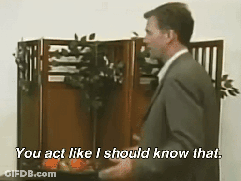 A Man In A Suit And Tie Is Saying You Act Like I Should Know That GIF