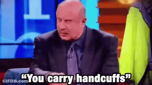 A Man In A Suit And Tie Is Saying " You Carry Handcuffs " . GIF