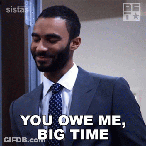 A Man In A Suit And Tie Is Saying You Owe Me Big Time GIF