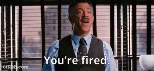 A Man In A Suit And Tie Is Saying `` You 'Re Fired '' In Front Of A Window . GIF