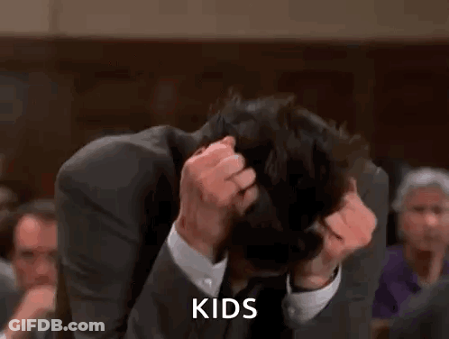 A Man In A Suit And Tie Is Scratching His Head And The Word Kids Is Visible . GIF