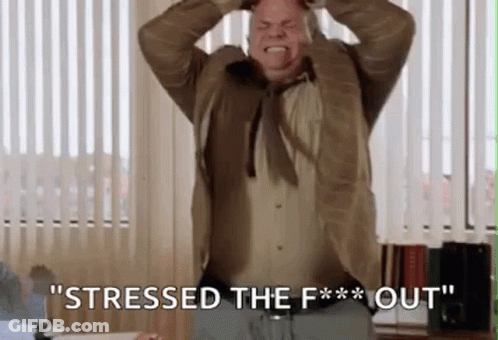 A Man In A Suit And Tie Is Screaming And Holding His Head While Saying `` Stressed The F ** Out '' . GIF