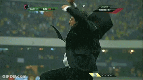 A Man In A Suit And Tie Is Screaming In Front Of A Screen That Says Mexico GIF