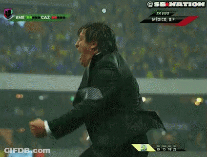 A Man In A Suit And Tie Is Screaming While Watching A Soccer Game In Mexico GIF