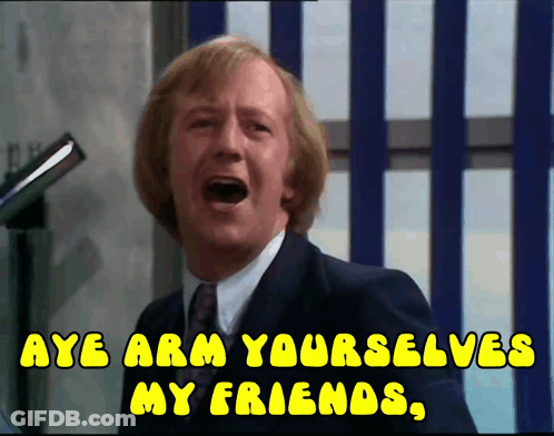 A Man In A Suit And Tie Is Screaming With The Words Aye Arm Yourselves My Friends GIF