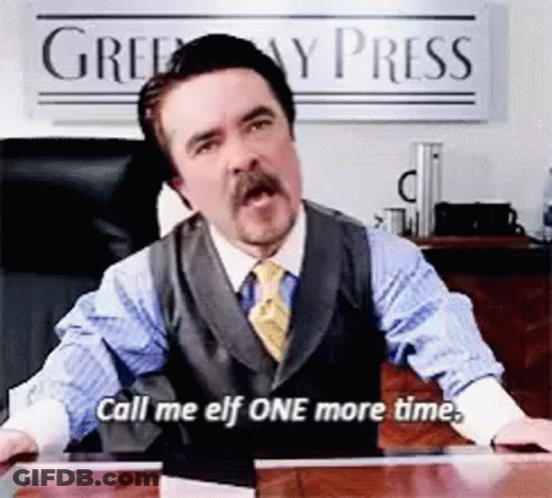 A Man In A Suit And Tie Is Sitting At A Desk And Says Call Me Elf One More Time GIF