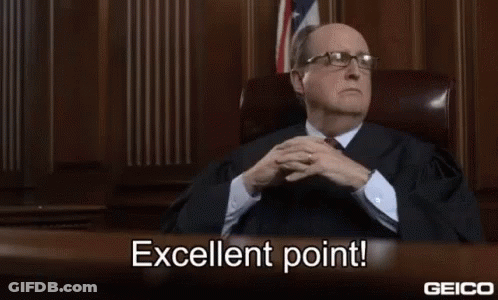 A Man In A Suit And Tie Is Sitting At A Desk In A Courtroom And Says Excellent Point . GIF