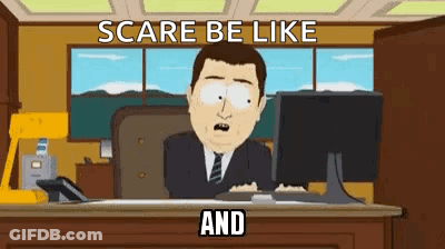 A Man In A Suit And Tie Is Sitting At A Desk In Front Of A Computer Monitor . GIF