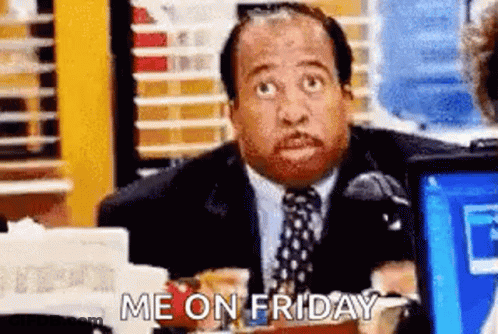 A Man In A Suit And Tie Is Sitting At A Desk In Front Of A Laptop Computer And Says `` Me On Friday '' . GIF
