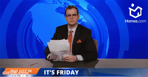 A Man In A Suit And Tie Is Sitting At A Desk In Front Of A Screen That Says " It 'S Friday " GIF