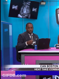 A Man In A Suit And Tie Is Sitting At A Desk With A Laptop And A Can Of Soda GIF