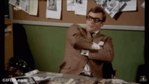 Man In Suit Sitting At Desk With Crossed Arms GIF