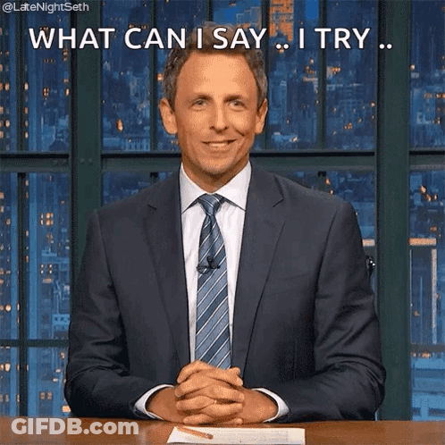 A Man In A Suit And Tie Is Sitting At A Desk With His Hands Folded And Says What Can I Say I Try . GIF