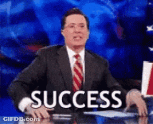 A Man In A Suit And Tie Is Sitting At A Desk With The Word Success In Front Of Him . GIF