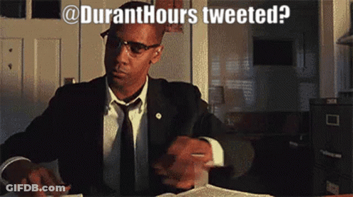 A Man In A Suit And Tie Is Sitting At A Desk With The Words " Duranthours Tweeted " Written Above Him GIF