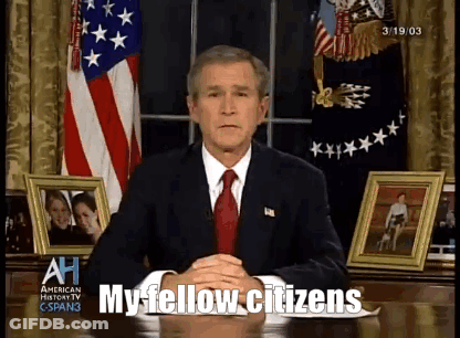 A Man In A Suit And Tie Is Sitting At A Desk With The Words My Fellow Citizens Written In Front Of Him GIF