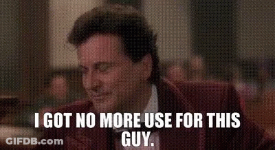 A Man In A Suit And Tie Is Sitting At A Table And Says `` I Got No More Use For This Guy '' . GIF