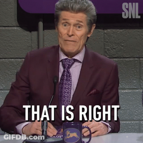 A Man In A Suit And Tie Is Sitting At A Table And Says That Is Right GIF