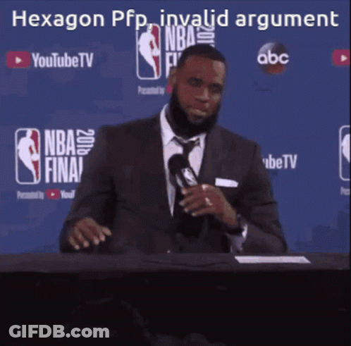 A Man In A Suit And Tie Is Sitting At A Table With A Microphone In Front Of A Sign That Says Youtube Tv GIF