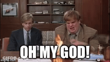 A Man In A Suit And Tie Is Sitting At A Table With A Toy Car On It And Says Oh My God . GIF