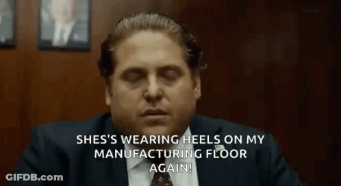 A Man In A Suit And Tie Is Sitting At A Table With His Eyes Closed And Talking . GIF