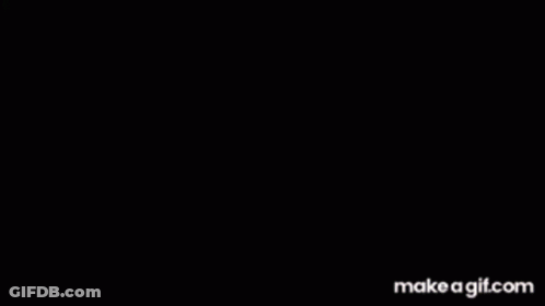 A Man In A Suit And Tie Is Sitting At A Table With His Head In The Air . GIF