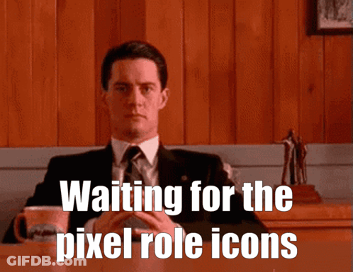 A Man In A Suit And Tie Is Sitting At A Table With The Words " Waiting For The Pixel Role Icons " Below Him GIF