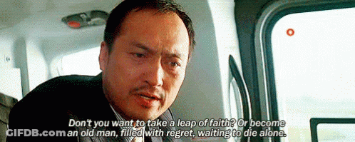 A Man In A Suit And Tie Is Sitting In A Car And Talking To Someone . GIF