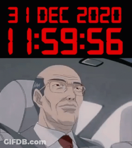A Man In A Suit And Tie Is Sitting In A Car Under A Digital Clock That Says 11:59 GIF