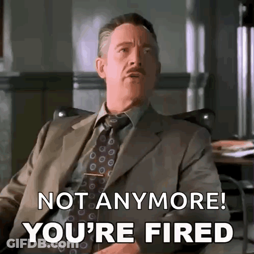 A Man In A Suit And Tie Is Sitting In A Chair And Saying `` Not Anymore ! You 'Re Fired '' . GIF