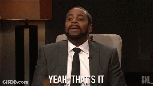 A Man In A Suit And Tie Is Sitting In A Chair And Saying Yeah That 'S It GIF