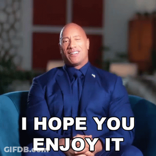 A Man In A Suit And Tie Is Sitting In A Chair And Says " I Hope You Enjoy It " GIF